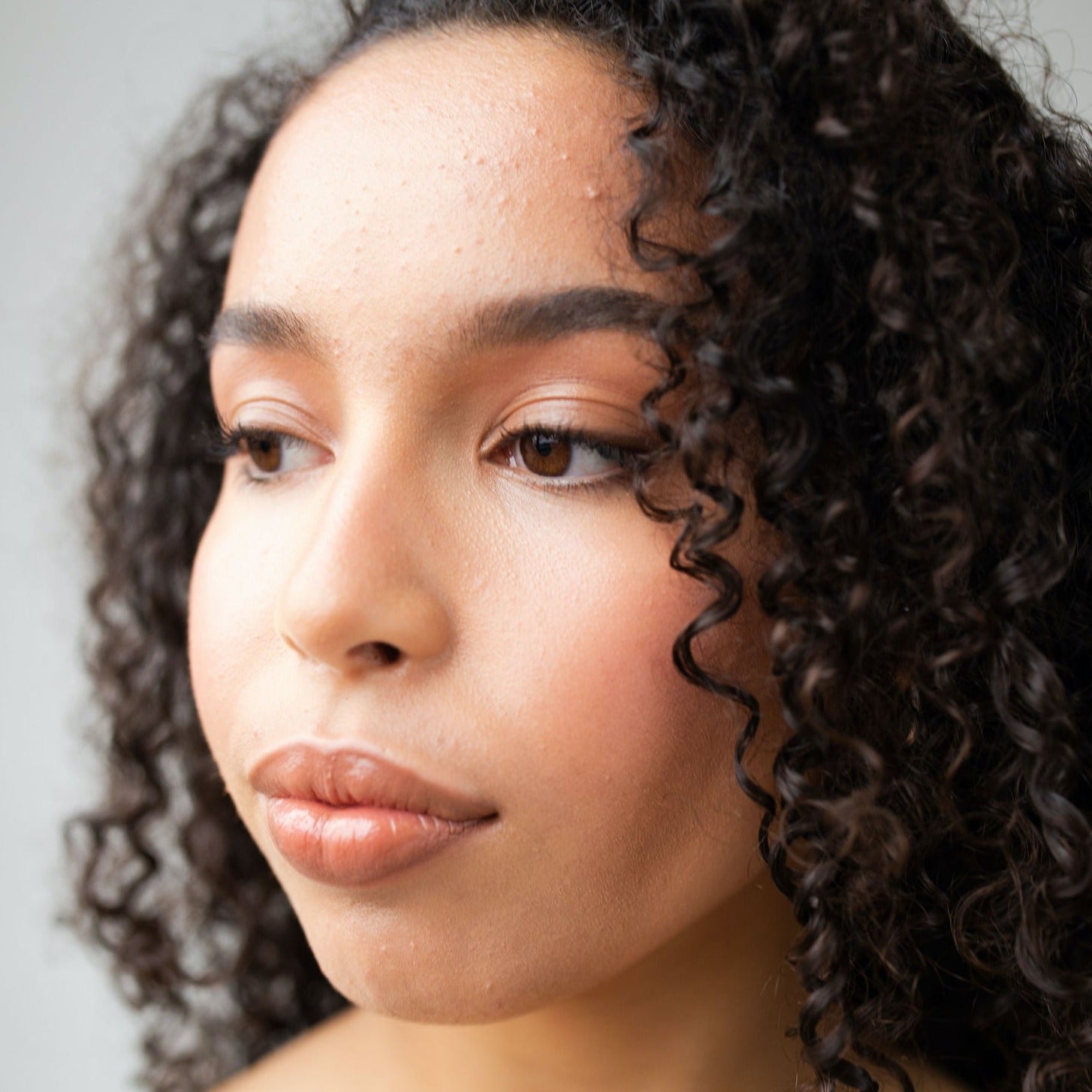 Mixed raced model wears Real Depth Multi Purpose Lip And Face Stick