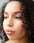 Mixed raced model wears Real Depth Multi Purpose Lip And Face Stick