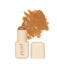 Pearl Beauty cream-colored makeup stick with a brown tip, shown next to its cap and a textured smear of the warm brown cosmetic product on a white background.
