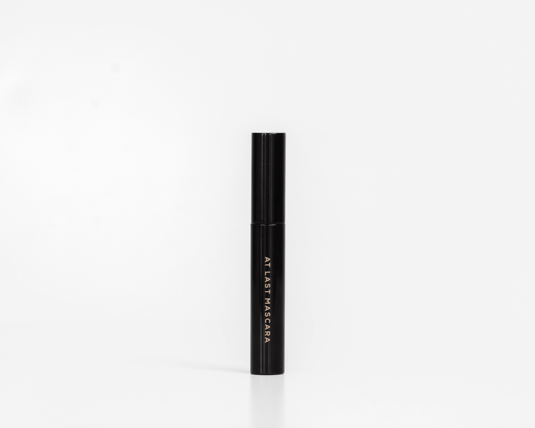 Black mascara tube on a white background