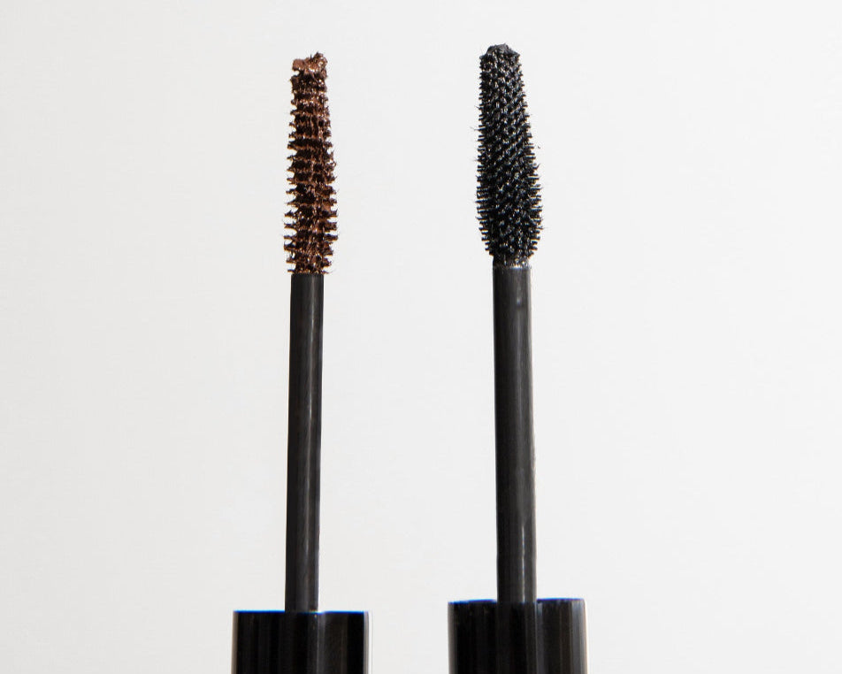 Two mascara wands, one with a black tip and one with a brown tip, against a white background, representing the black and brown bundle product.