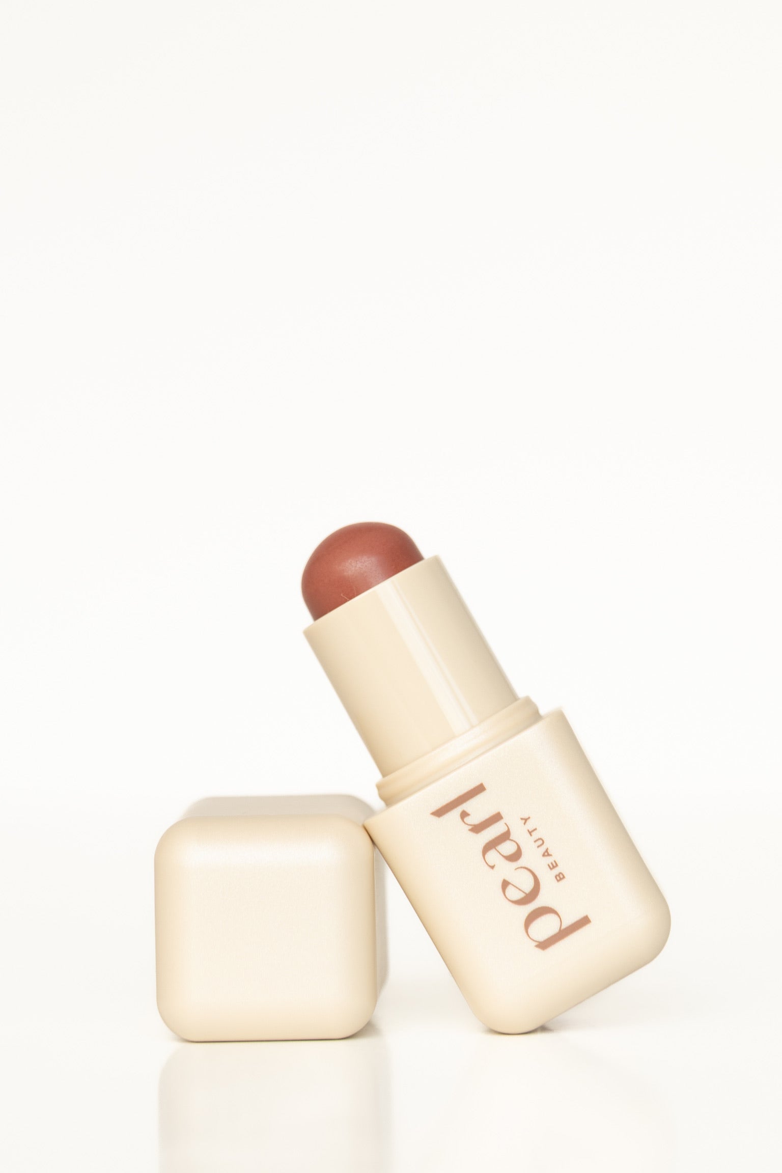 Product shot of Pearl Beauty Core Four Put Together cream blush stick medium rose colour cream blush vegan cruelty-free