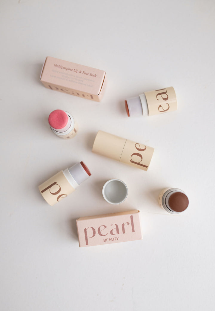 All Core Four Beauty Sticks from above, laying on table amongst their packaging.
